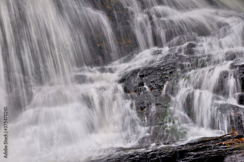 Closeup of white curtains of water plunging down scenic Garwin Falls in Wilton  New Hampshire.