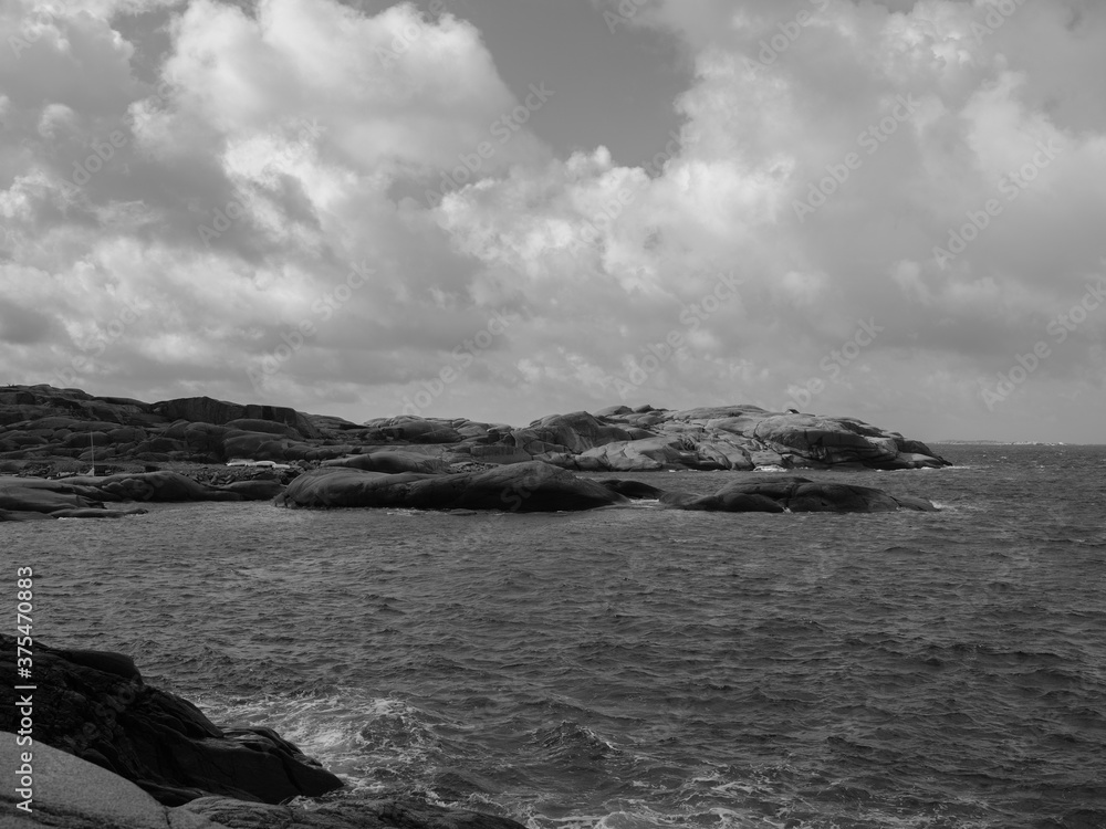 Coastline in Sweden with granite rocks and weathered cliffs in a monochrome photograph