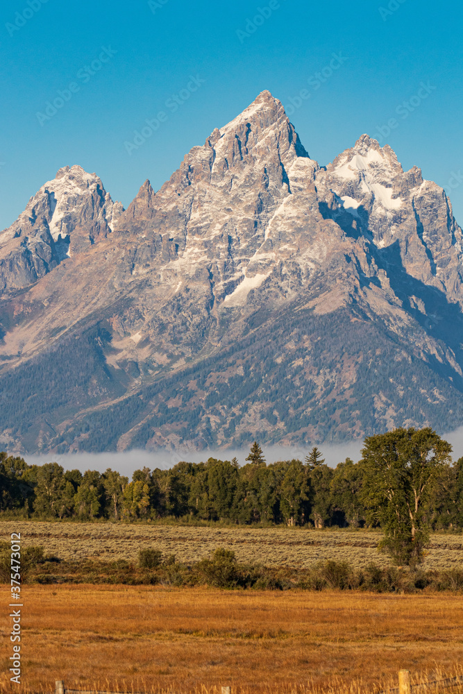 Vertical photo - Grand Teton mountain in morning light during Fall in Grand Teton National Park Vertical photo - Grand Teton mountain in morning light during Fall in Grand Teton National Park