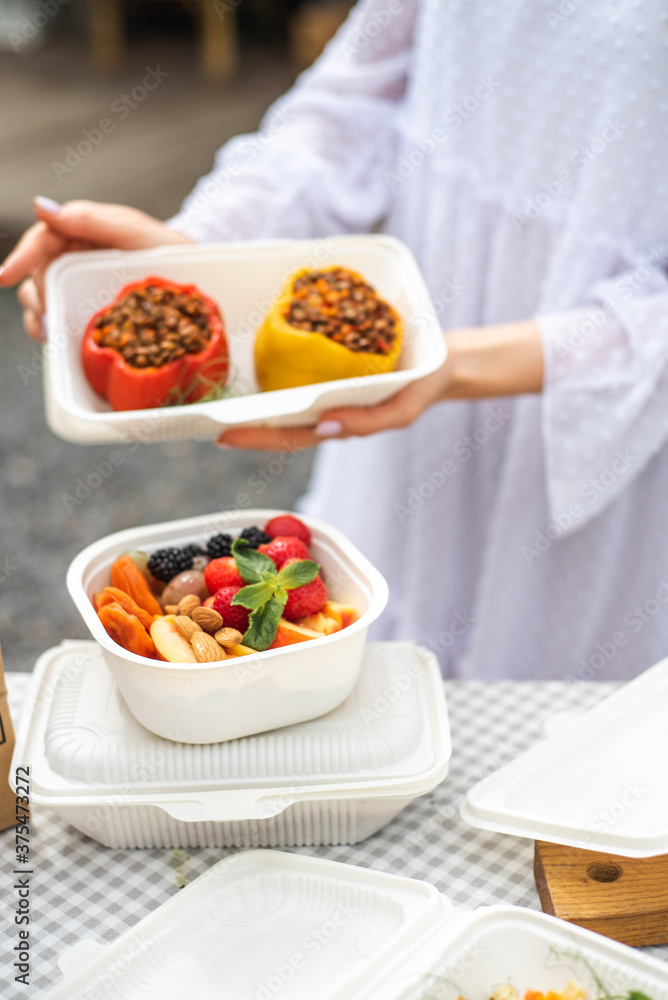 Sat of take away boxes with healthy food on the table. Restaurant dishes. stuffed pepper in hands