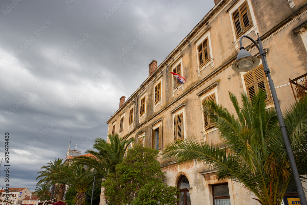 Stari Grad/Croatia-August 7th,2020: Beautiful, worn out facade of old house on the edge of waterfront in the oldest town on Hvar island, Croatia, under the cloudy sky
