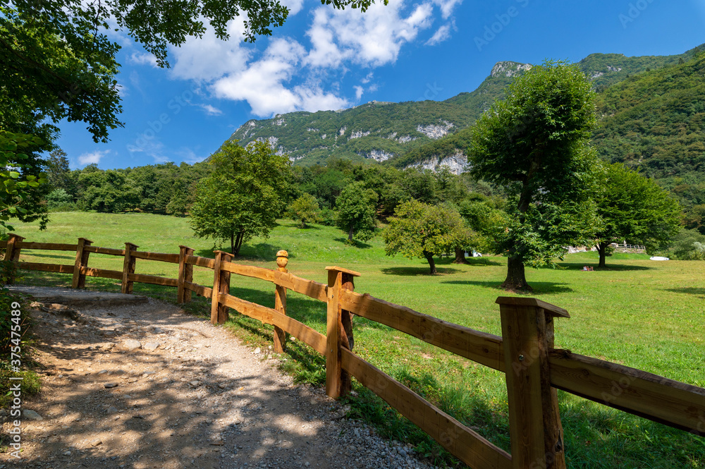 Summer panorama in the mountains and wooden fence near the lake of tenno, wine route, near Lake Garda, Riva del Garda, Trentino Alto Adige, Trento, Italy