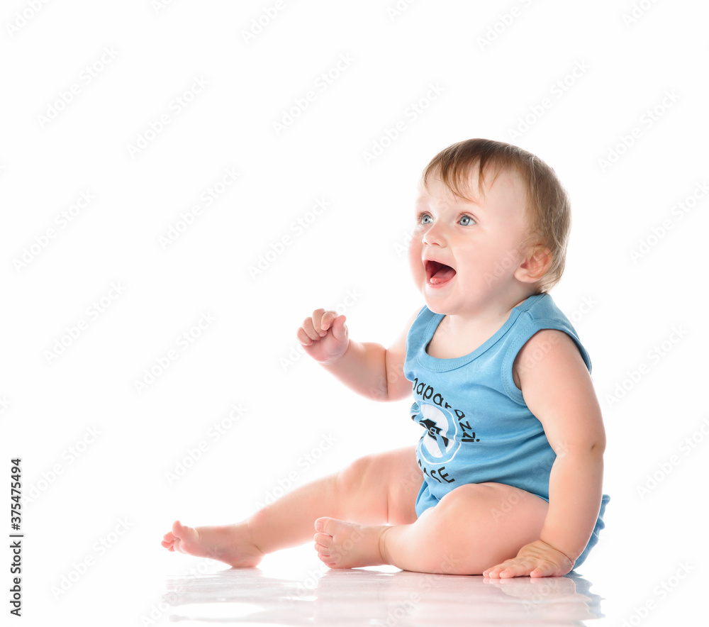 Baby toddler pleasantly surprised looking up on a white background. Baby toddler pleasantly surprised looking up on a white background.