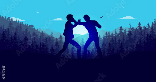 Fight in forest - Two people fighting at sunset with forest in background.