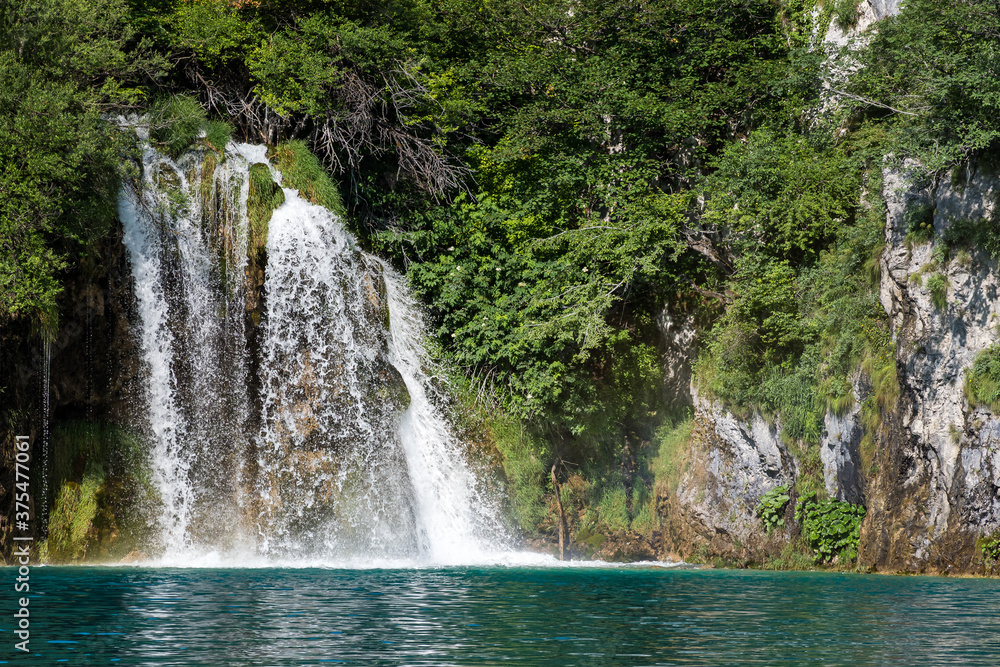 Fototapeta premium Waterfall with turquoise water in the Plitvice Lakes National Park, Croatia.