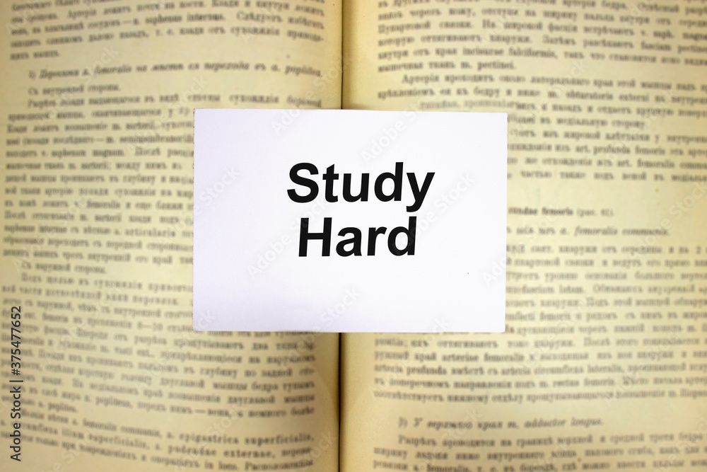 Obraz premium Study hard written in white note on open book