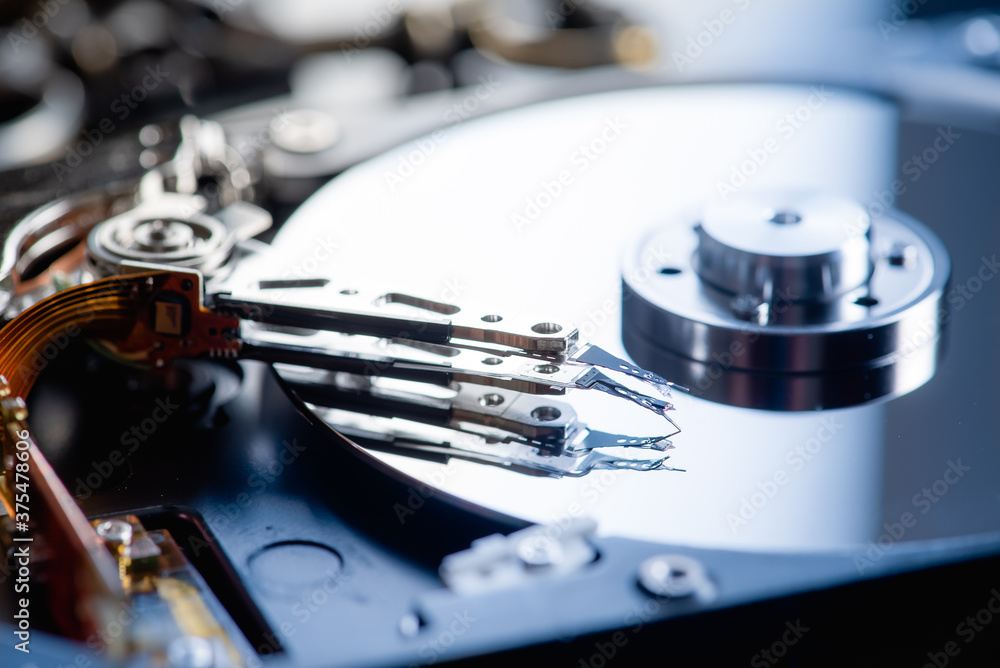 Low key, disassembled hard drive, on a black reflective background, information protection, restrained key, there is a place for an inscription Low key, disassembled hard drive, on a black reflective background, information protection, restrained key, there is a place for an inscription