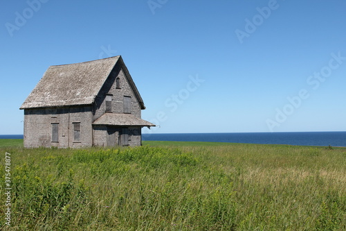 abandoned dream house with field and ocean 2