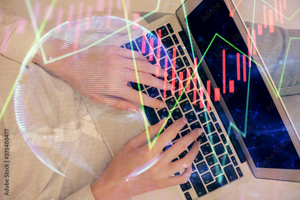 Double exposure of woman hands working on computer and forex graph hologram drawing. Top View. Financial analysis concept. Double exposure of woman hands working on computer and forex graph hologram drawing. Top View. Financial analysis concept.