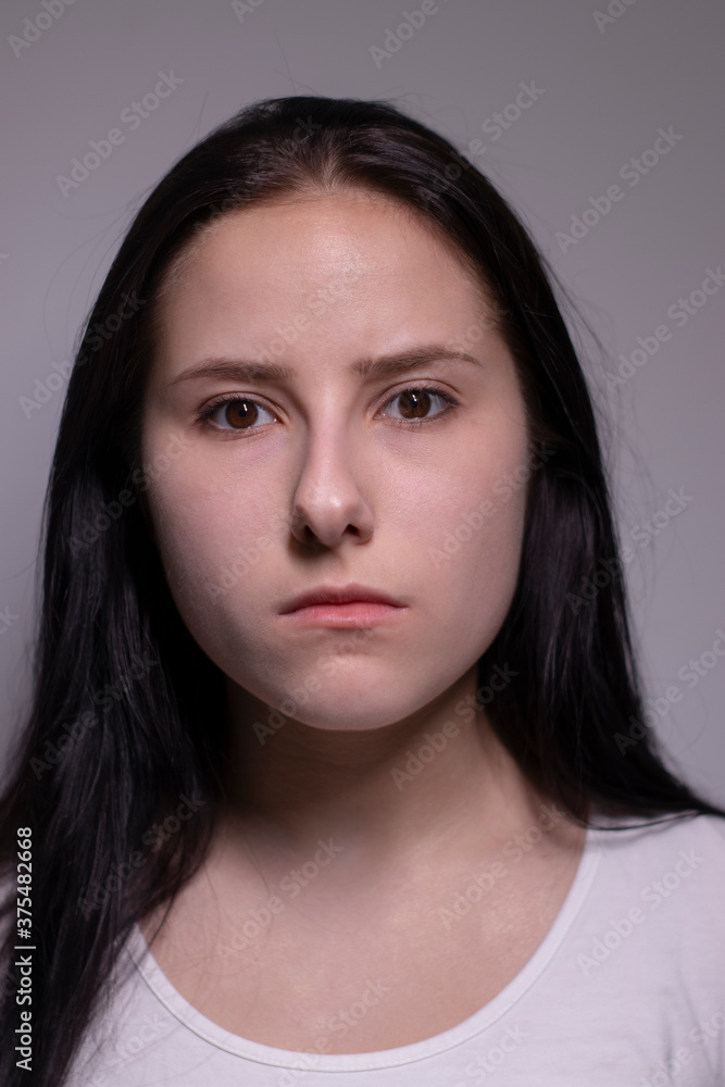  portrait of sad and depressed young woman. on gray background. nervous and upset people concept.