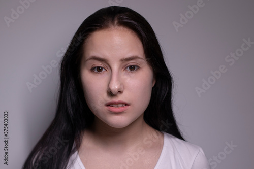  portrait of sad and depressed young woman. on gray background. nervous and upset people concept.