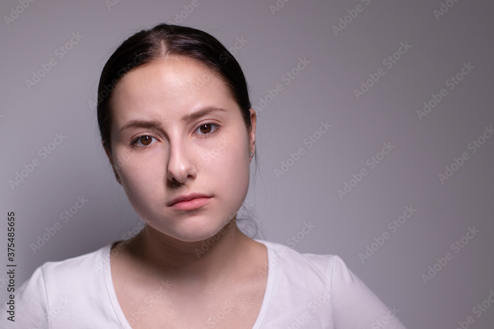portrait of sad and depressed young woman. on gray background. nervous and upset people concept. portrait of sad and depressed young woman. on gray background. nervous and upset people concept.