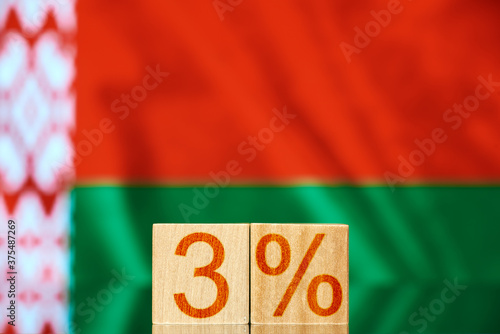 3% belarus. wooden blocks with the inscription 3% on the background of the flag of Belarus. the concept of revolution in Belarus photo