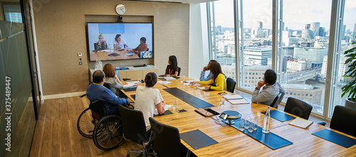 Business people video conferencing in conference room meeting photo