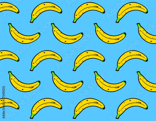 Yellow Banana repetition pattern over blue background. Fashion, meals and decorative concept
