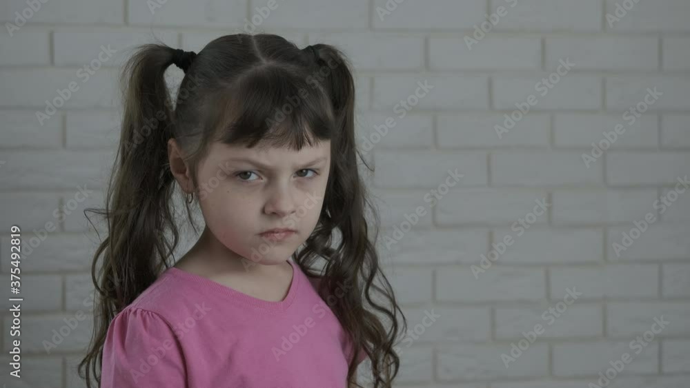 Start to boxing. The little girl looks at the camera in disbelief, then stands up in boxing gloves. Start to boxing. The little girl looks at the camera in disbelief, then stands up in boxing gloves.