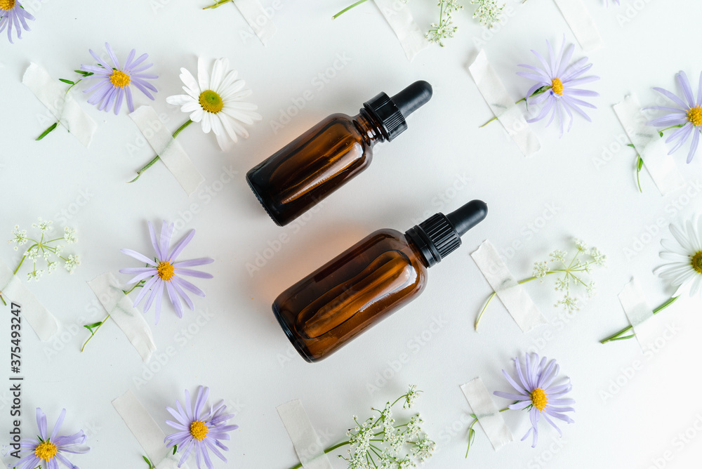 Bottles of essence and surum for skin health on background of flowers. Natural herbal Skin care cosmetics in dark glass. Mockup advertising.
Nourishing face oil Bottles of essence and surum for skin health on background of flowers. Natural herbal Skin care cosmetics in dark glass. Mockup advertising.
Nourishing face oil