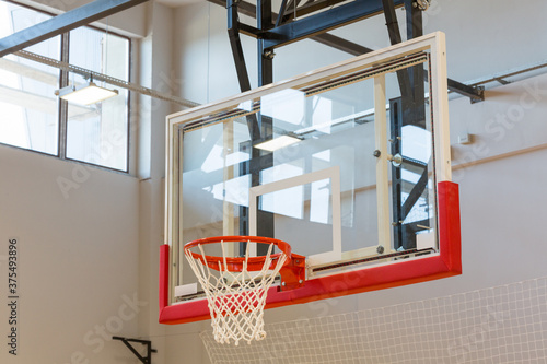 Basketball backboard and hoop in sport hall photo