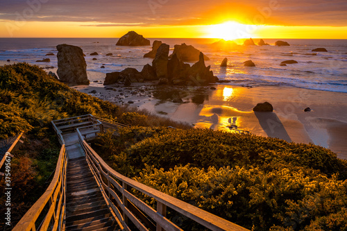 Dramatic Sunset at Bandon Beach with stairs leading to beach level. photo