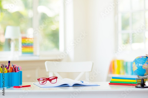 Back to school. Kids desk with books, globe.