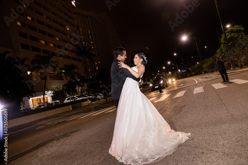 Latino Bride and Groom dancing in the middle of the street
