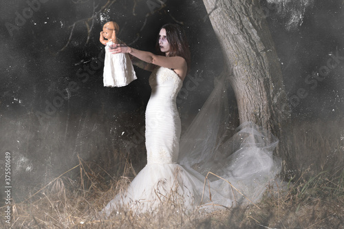 Horror Scene of a Woman Possessed holding a doll. High quality photo