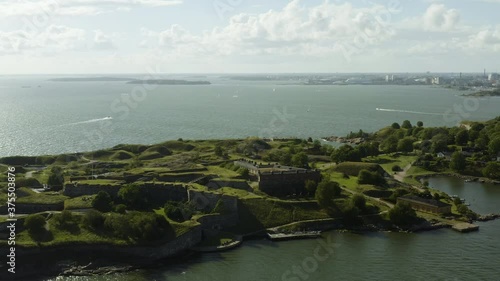 Aerial view around the Susisaari island, at the Suomenlinna UNESCO world heritage site, boats in the background, sunny, summer day, in Helsinki, Finland - circling, drone shot photo