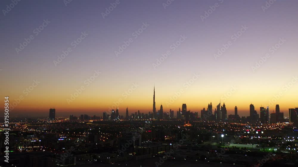 Magnificent extreme long aerial viwe of the city on a twilight horizon as the camera pan to the left with the Burj Khalifa stand still , 6-axis stabilized gimbal, Shotover F1, 8K. Magnificent extreme long aerial viwe of the city on a twilight horizon as the camera pan to the left with the Burj Khalifa stand still , 6-axis stabilized gimbal, Shotover F1, 8K.