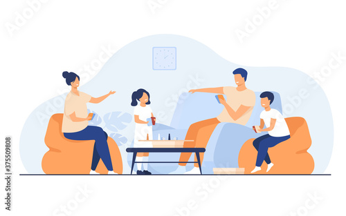 Family home activities concept. Happy boy and girl with parents playing board games with cards and dices in living room. For entertainment, togetherness, having together topics