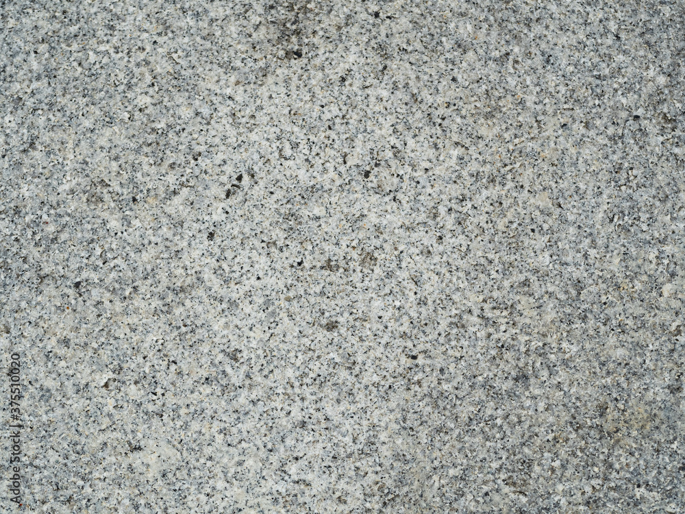 The texture of a granite stone. Top-down close-up view. The texture of a granite stone. Top-down close-up view.