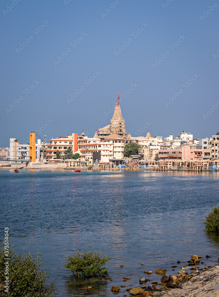 Gomathi ghat and view of Dwarkadheesh temple, Gujrat, India with clear blue sky.