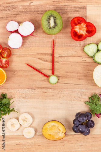 Clock made of fruits and vegetables showing time 10 am, time for healthy breakfast concept