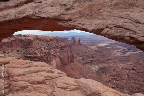 View of  Mesa Arch at island in the sky and landscape of Canyonlands National Park appearing under the arch in Utah  USA