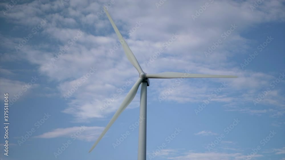 Wind Turbine  Propellers Spinning With Blue Sky And Clouds On The Background. - wide shot