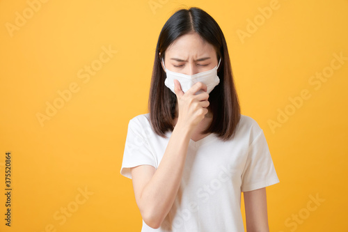 Asian women wear masks to protect disease on orange background.
