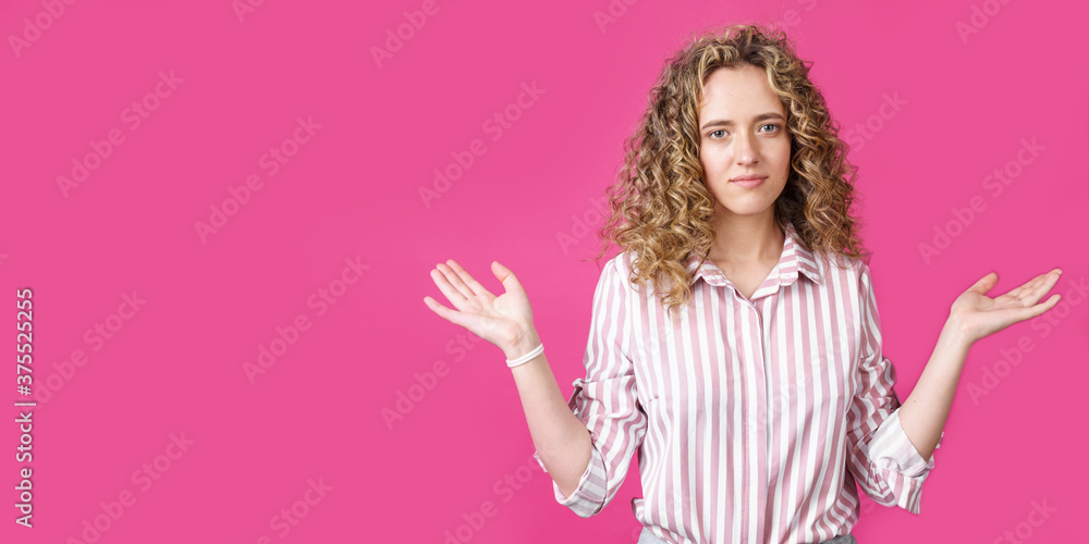 Portrait of a woman who holds her hands up, palms up.