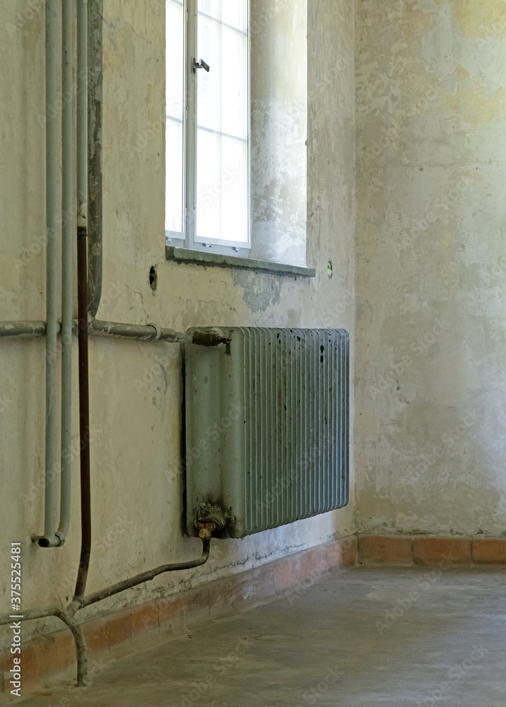 Old radiator in an empty historic home
