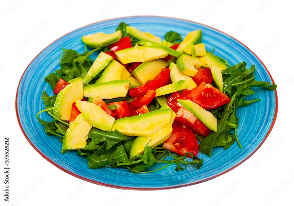 Salad with tomato, arugula, avocado, lemon juice and olive oil. Isolated over white background