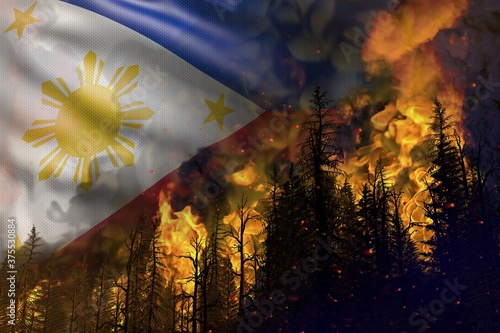 Forest fire fight concept  natural disaster - heavy fire in the woods on Philippines flag background - 3D illustration of nature