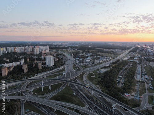 Aerial view panoramic landscape of Moscow city at sunrise. Multi-level intersection on an expressway in the city in the rays of the golden sun. Drone shot © Max