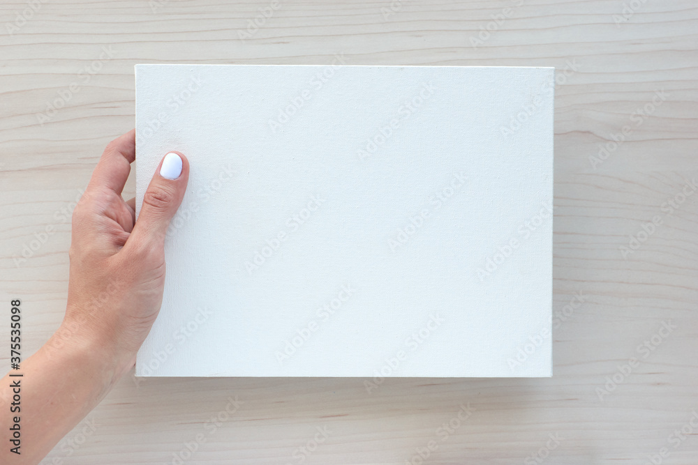 White board with hands for copy space. School office supplies on wooden background. Back to school concept. Top view ready for your design. White board with hands for copy space. School office supplies on wooden background. Back to school concept. Top view ready for your design.