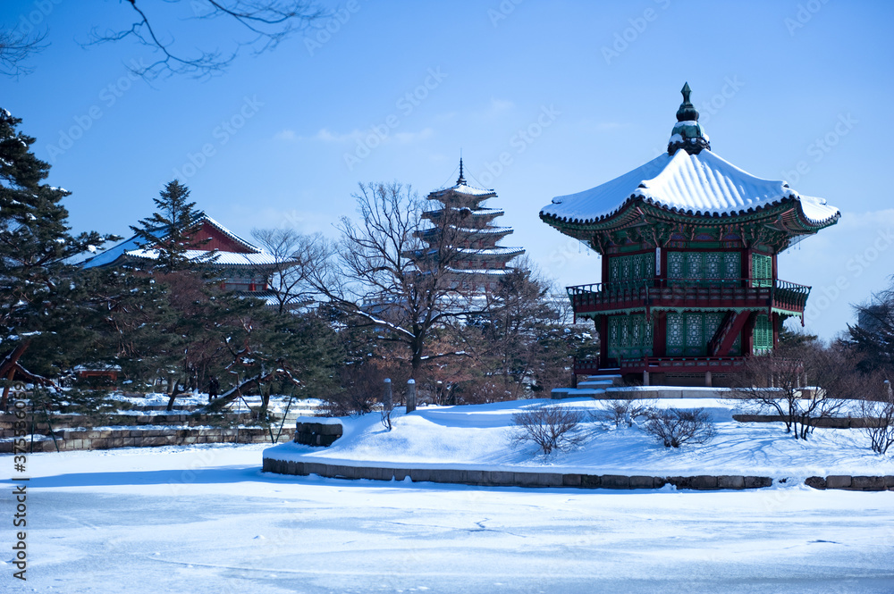 The beautiful snowy palace  with lake reflections.