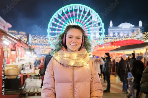 Winter portrait of happy young female teenager at the Christmas market © Valerii Honcharuk