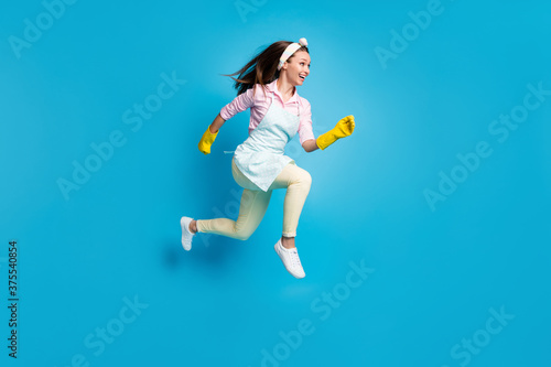 Fototapeta Naklejka Na Ścianę i Meble -  Full length body size profile side view of her she nice attractive cheerful cheery motivated maid jumping running active isolated on bright vivid shine vibrant blue color background