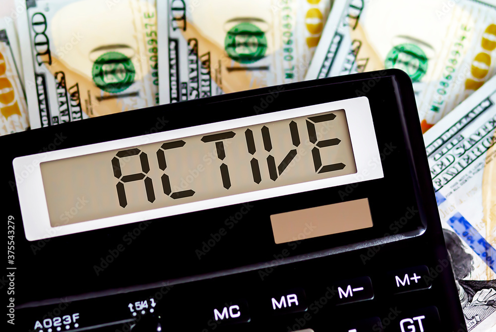 Calculator with text ACTIVE on the dollars. Business, finance conceptual. Calculator with text ACTIVE on the dollars. Business, finance conceptual.