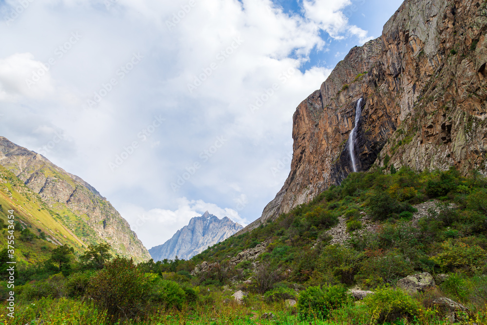 Mountain landscape with a river and a waterfall. Summer background. Belogorka gorge, Kyrgyzstan