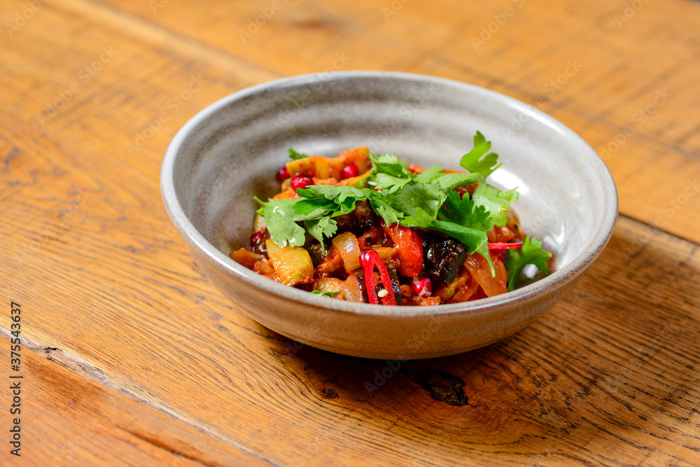 Georgian vegetable and meat salad with onion, basil, tomato, parsley and pepper. Georgian vegetable and meat salad with onion, basil, tomato, parsley and pepper.