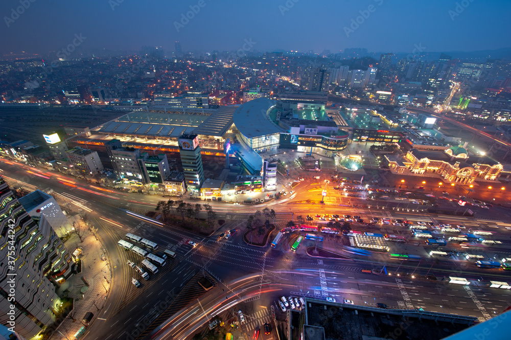 Fototapeta premium The wonderful night view of cityscape and car light.