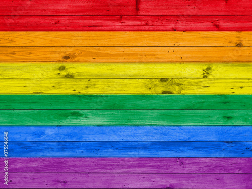 colorful rainbow lgbt flag on wood panel wall background.
