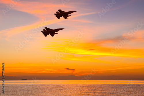 Silhouette airplane with beautiful colorful sunset sky background.